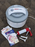Nesco American Harvest food dehydrator has five trays, works; comes with a sausage jerky gun.
