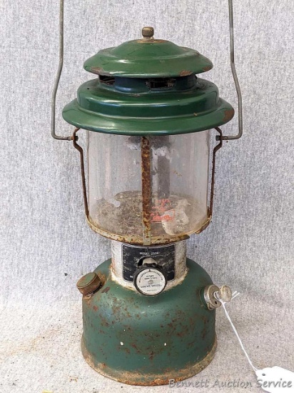 Coleman double-mantle lantern is Model 220H and has the smaller shade. About 14" tall. Bottom is