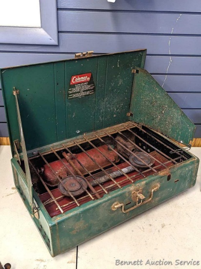 Coleman dual-burner camp stove is Model 413G. Didn't see a date code. Measures about 22" x 13" x 6",