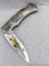Red Dragon Folding Knife in a pocket knife style but unless you are Andre the Giant it won't fit in
