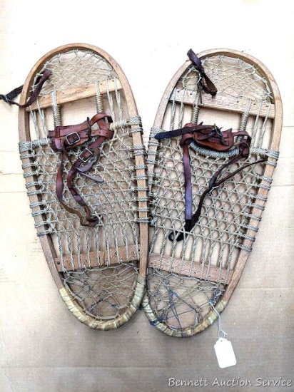 Vintage Swenson & Swenson Bearpaw snowshoes with leather bindings are 29" long and 12-1/2" wide.