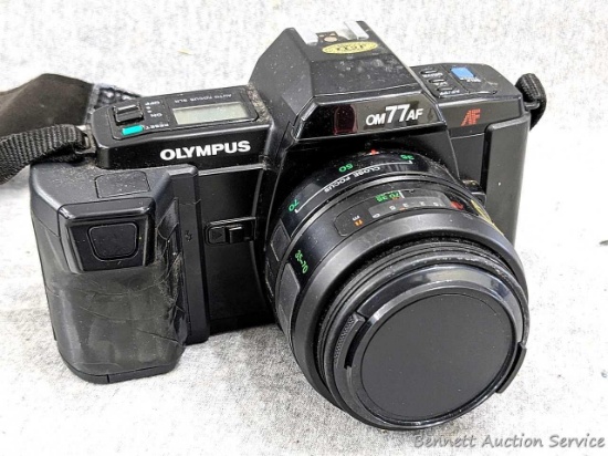 Olympus ON77AF film camera with manual. Camera in nice condition and about 6-1/2" wide. Feature Auto