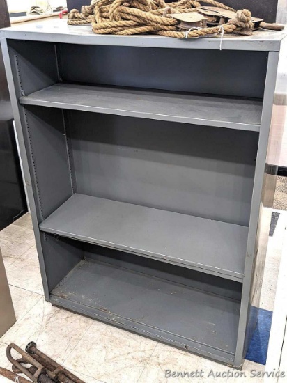 Steel shelving unit with positionable shelves is about 4' tall x approx 3' wide and 12-1/2" deep.