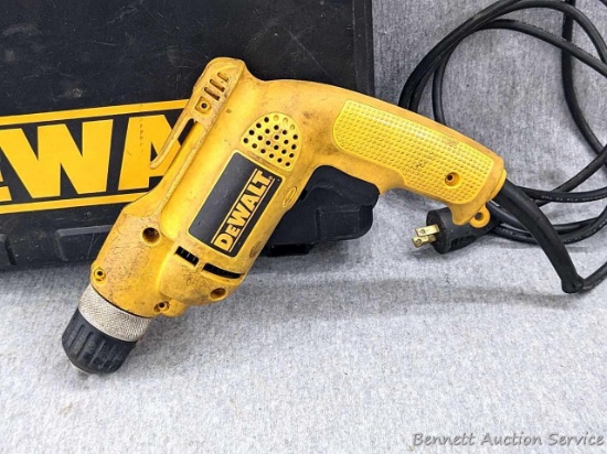 DeWalt D21008 VSR drill with 3/8" drive comes with manual and case. Runs F/R with slight ticking as