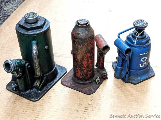 Trio of bottle jacks with no jacking handle; Green bottle jack stands 9" tall