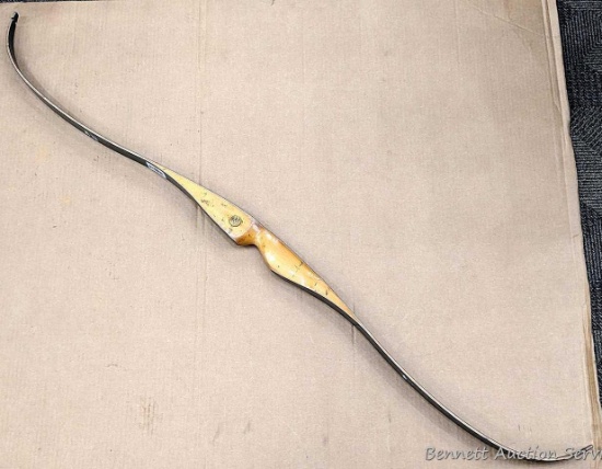 Bear brand Black Bear recurve bow measures 57" long unstrung. No delamination, bow in good condition