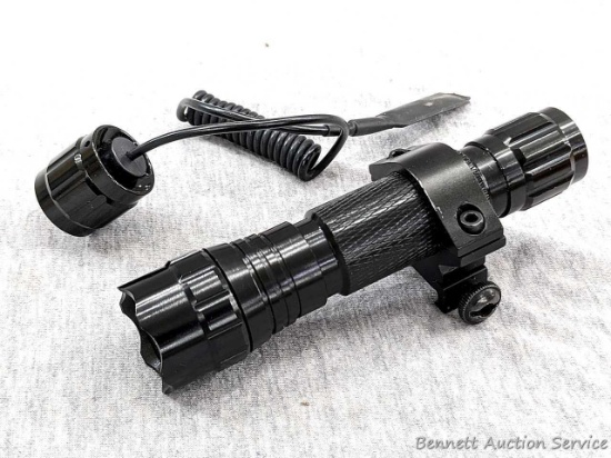 Picatinny rail mount rifle barrel flashlight with grip switch and paperwork. Works and is in good