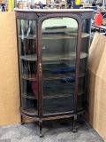 Gorgeous antique cabinet with curved glass side panels and classy trim around top of door. Measures