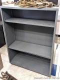 Steel shelving unit with positionable shelves is about 4' tall x approx 3' wide and 12-1/2