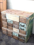 Storage and organizer system that appears to be an old library card catalog. Some drawers contain