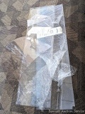3 pieces of Plexiglass. One appears to have been a windshield in its previous life. Other sheets of