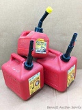Trio of gasoline totes, larger two are 2 gallon capacity.