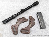 Seven round 1911 magazine, rifle scope, and clip on quiver.