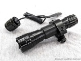 Picatinny rail mount rifle barrel flashlight with grip switch and paperwork. Works and is in good