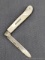 Antique fruit knife with a sterling silver blade, mother of pearl handle slabs, and attractive file