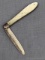 Antique fruit knife with a sterling silver blade, a twisted looking mother of pearl handle slabs,