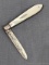 Antique fruit knife with an engraved sterling silver blade, mother of pearl handle slabs, tooled