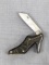 Figural ladies high heel shoe pocket knife has brass liners and good handle slabs. Measures 2-1/4