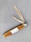 Vintage Remington folding pocket knife with two blades. The knife has chipped bone or stag handles