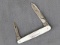 Vintage Remington folding pocket knife with two blades, and mother of pearl handle slabs. The knife