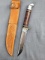 Western fixed blade knife with a tooled leather sheath. The knife is in very good condition with an