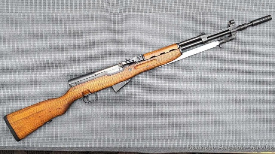 Yugoslavian SKS rifle with grenade sight, blade bayonet, muzzle attachment, and flip-up night sight.