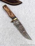 Seller notes this handmade damascus knife is 1095 and 15N20 steel. The knife has a 5 1/4