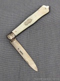 Antique fruit knife with a sterling silver blade, tooled mother of pearl handle slabs, and