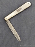 Antique fruit knife with a sterling silver blade, mother of pearl handle slabs, attractive file work