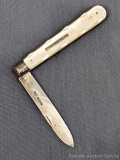 Antique fruit knife with a sterling silver blade, mother of pearl handle slabs, nice tooling on