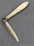 Antique fruit knife with a sterling silver blade, a twisted looking mother of pearl handle slabs,