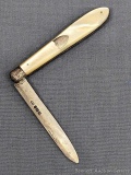 Antique fruit knife with a sterling silver blade, mother of pearl handle slabs, and attractive file