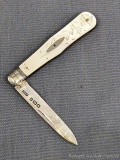 Antique fruit knife with a sterling silver blade, and engraved mother of pearl handle slabs. The
