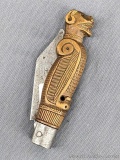 Early antique folding pocket knife with a totem pole or tribal looking handle. The knife measures 5