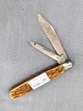 Vintage Remington folding pocket knife with two blades. The knife has chipped bone or stag handles