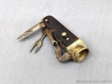 Miniature hobo or smoker's knife has a cigar nipper, fork, and knife blade. Tortoise shell handle