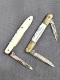 Two vintage folding pocket knives, one with ivory colored bone or similar handles, the other with