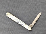 Vintage single blade folding pocket knife with tooled mother of pearl handles. The knife is in good