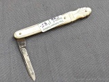 Vintage single blade folding pocket knife with tooled mother of pearl handles. The knife is in good