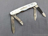 Vintage folding knife with mother of pearl handles, three blades and a nail blade. The knife is in