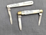 Two folding pocket knives with single and double blades, and mother of pear handles. The knives are