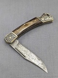 Exploder 11 - 444 damascus style knife. The knife is in good condition with a tight hinge, strong