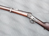 Most of an antique Remington rolling block rifle with receiver marked ARO or HRO 1876 under crown.