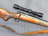 Winchester Model 70 bolt action rifle chambered in .270 Win. is topped with a Redfield 2x-7x scope