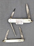 Two vintage Remington folding pocket knives with mother of pearl handle slabs. Both knives are in
