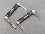 Two Vintage I XL George Wostenholm folding pocket knives with chipped bone or stage handles. The G