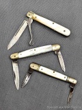 Three vintage folding pocket knives with mother of pearl handles. All three knives are in good