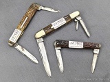 Three vintage folding pocket knives by Wregg, and others, with chipped bone or stag handles. All the