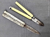 Two vintage miniature buttery fly knives, and scissors. The one with ivory colored handles measures