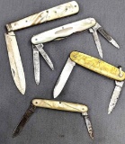Four vintage folding knives by Harrison, Remington, and others. The knives are in good condition